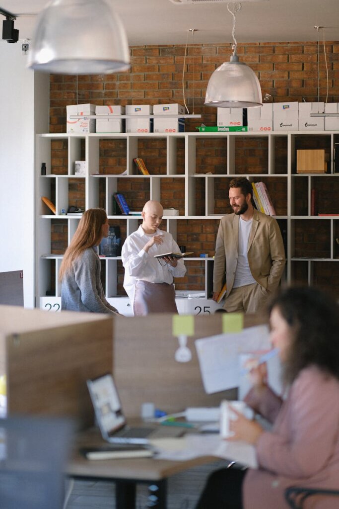 Team of coworkers gathering in open space office and sharing business and project issues together